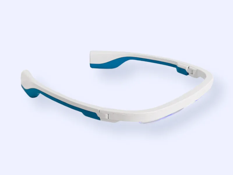 A pair of white and blue smart glasses with a sleek, modern design, resting on a light background. The glasses have no visible lenses and feature a streamlined, wraparound frame.