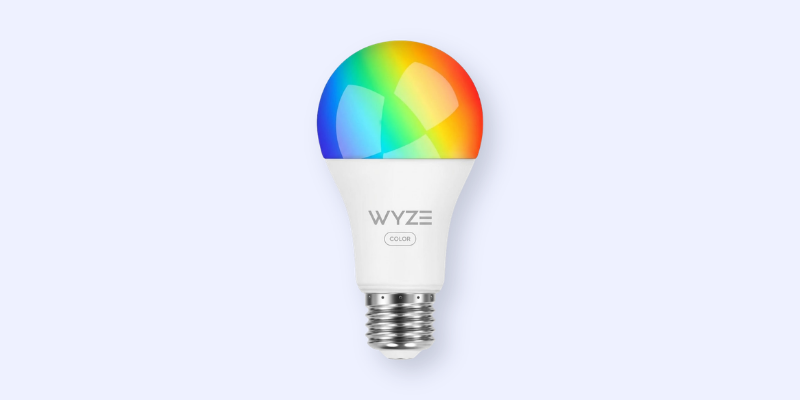 A white Wyze smart LED light bulb with a screw base and a colorful gradient on the top half, displaying red, orange, yellow, green, and blue hues, against a light gray background.
