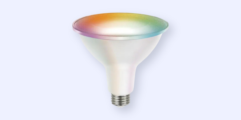 A single smart LED light bulb with a silver base and a wide, slightly iridescent top, reflecting a gradient of rainbow colors, on a light blue background.