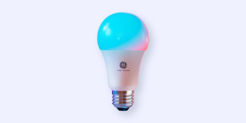 A GE smart LED light bulb glows with blue and pink colors against a pale background. The bulb has a metallic screw base and the GE logo printed on its white body.