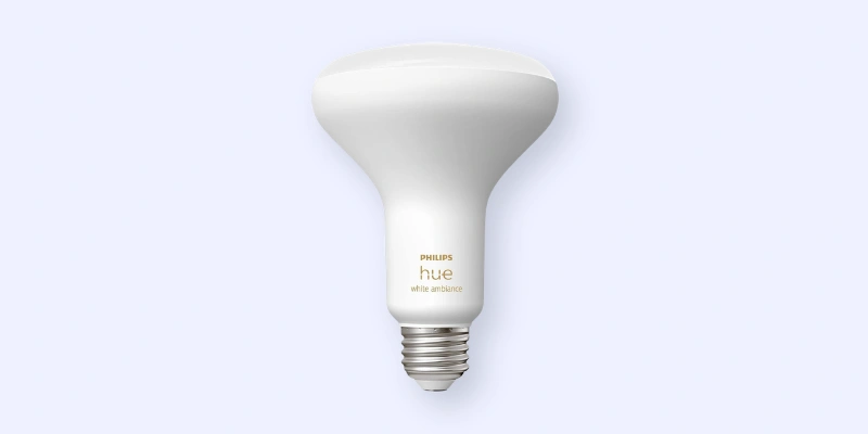A Philips Hue white ambiance smart light bulb with a wide, flat top and screw base, set against a plain light background.