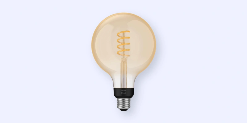 A round, vintage-style LED light bulb with a visible spiral filament and a black base, shown against a light gray background.