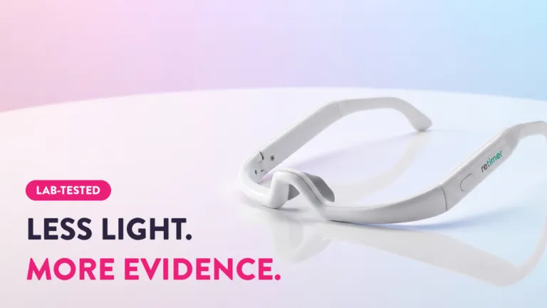 Re-timer light therapy glasses on white surface with "Less Light. More Evidence." lab-tested sleep aid tagline