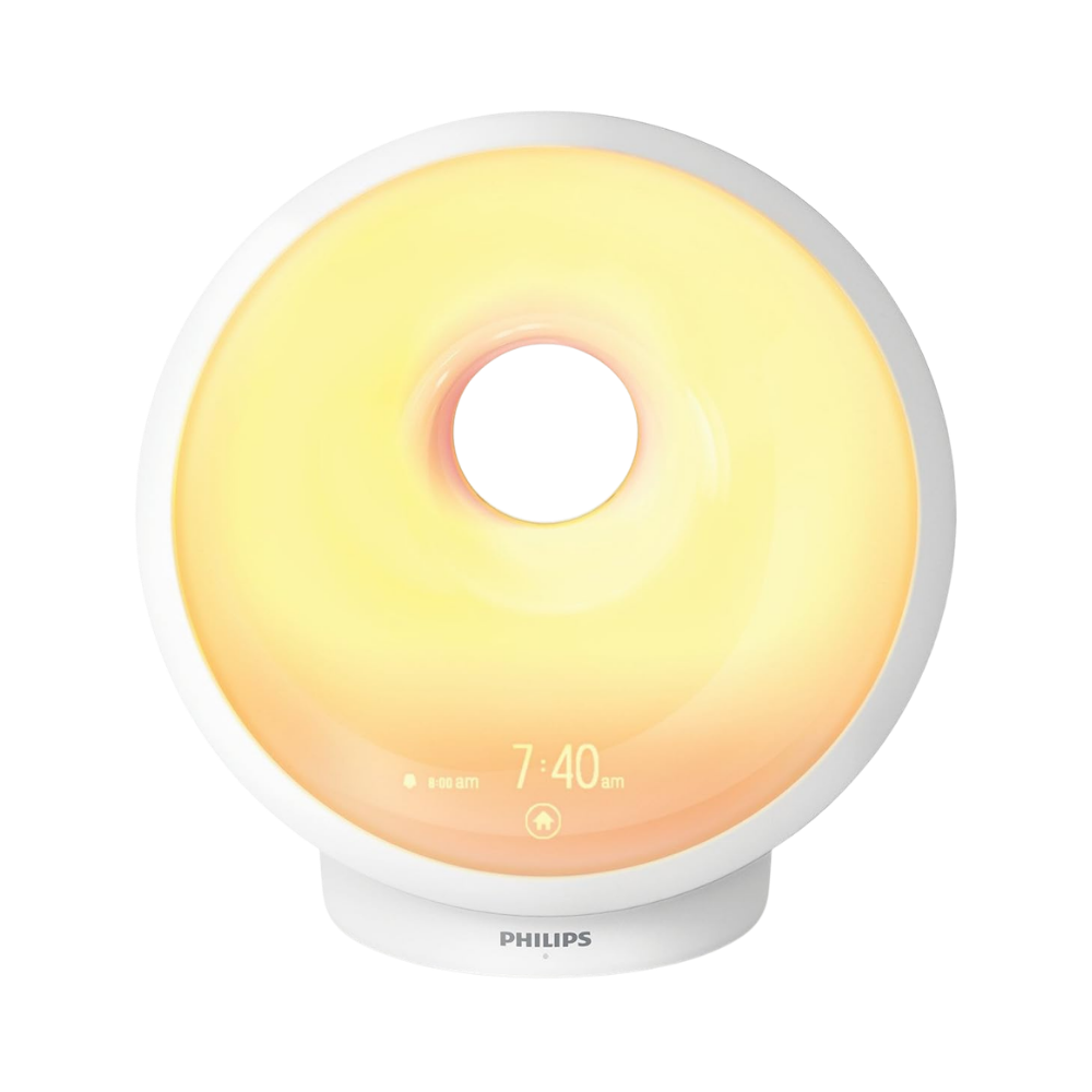 Philips SmartSleep wake-up light alarm clock with sunrise simulation glowing warm orange at 7:00