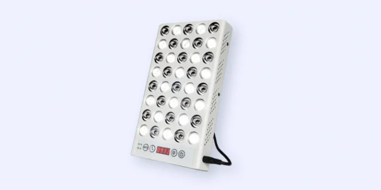 A rectangular LED therapy light panel with 32 circular bulbs, control buttons, and a digital display on its front, positioned at an angle against a light background. A power cord extends from the side.