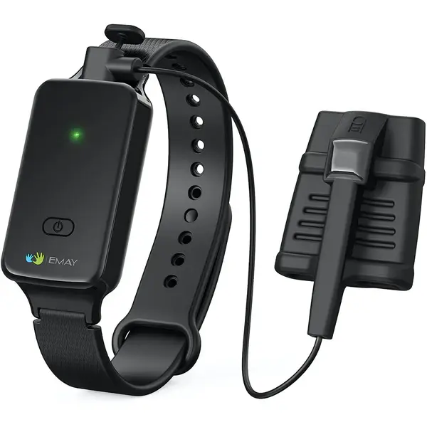A black wrist-worn pulse oximeter with an adjustable strap, a green indicator light, and a wired sensor clip attachment, used for measuring blood oxygen levels and pulse rate.