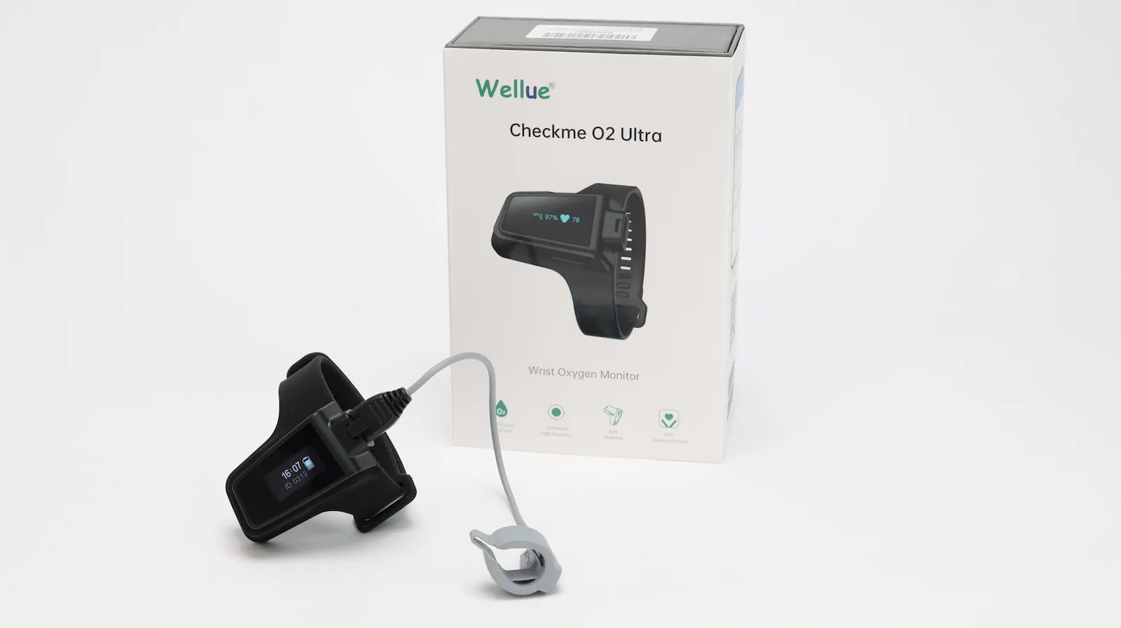 A Wellue Checkme O2 Ultra wrist oxygen monitor is shown in front of its product box, with a wristband, display screen, and a finger sensor attached by a cable.