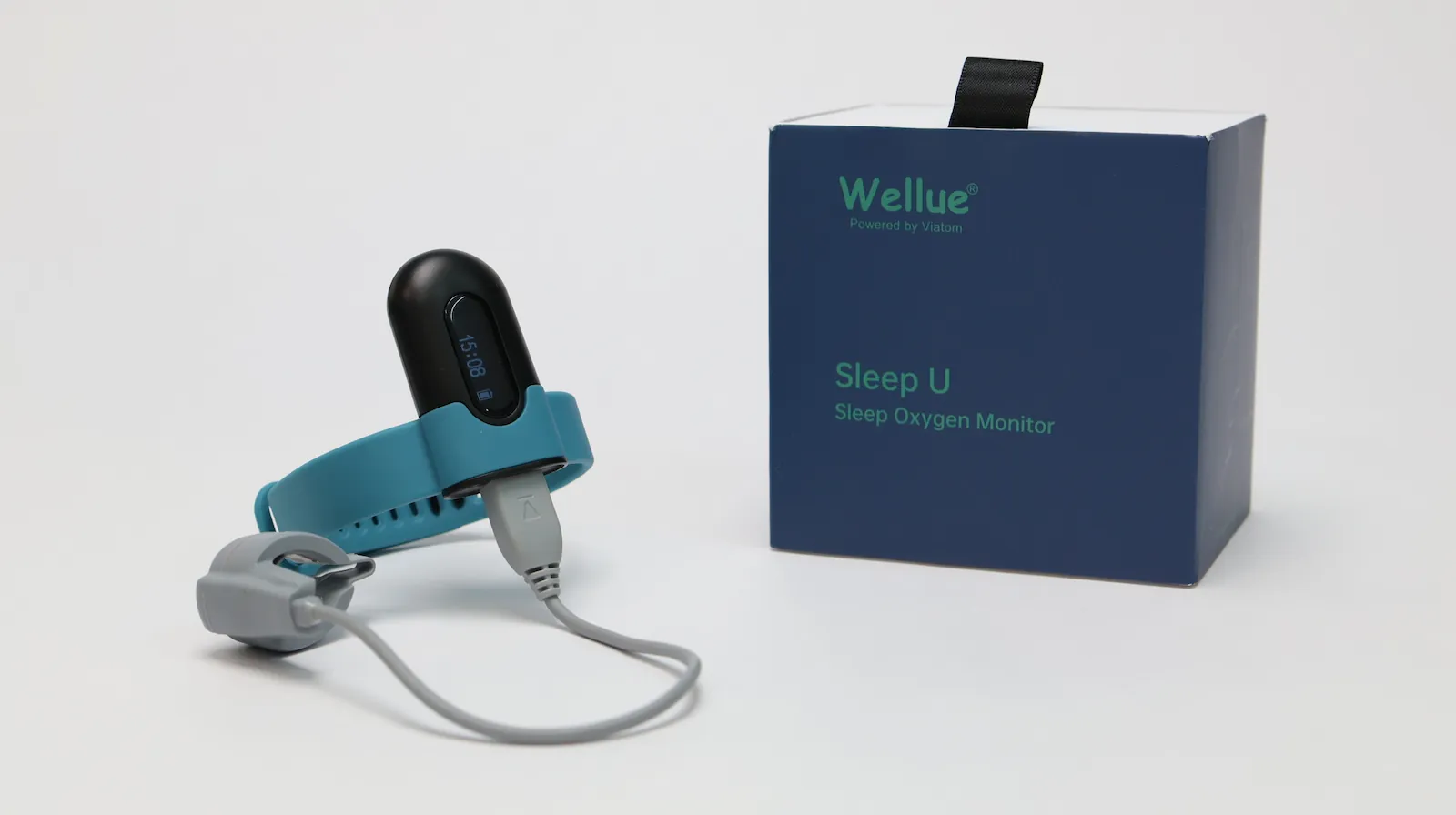 A Wellue Sleep U Sleep Oxygen Monitor with a blue wristband and connected fingertip sensor is displayed next to its blue box packaging on a white background.