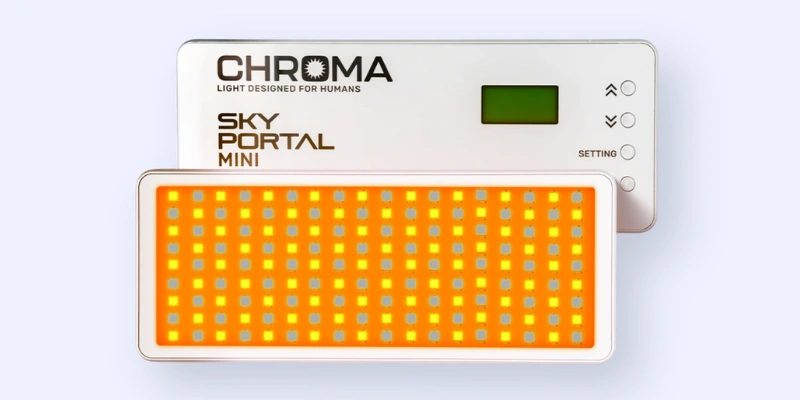 A rectangular device labeled CHROMA SKY PORTAL MINI with an orange and yellow LED panel in front and a control panel with buttons and a small screen behind it.