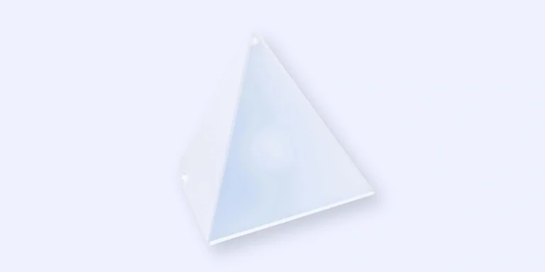 A translucent, white, four-sided pyramid with smooth surfaces is shown against a plain, light background.
