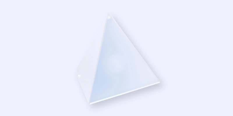 A translucent, white, four-sided pyramid with smooth surfaces is shown against a plain, light background.