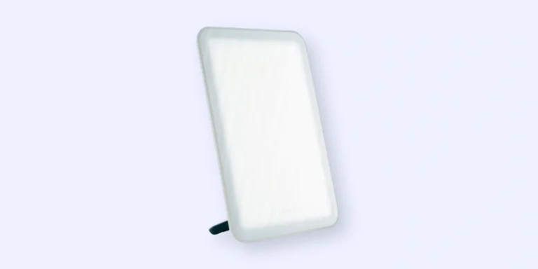 A rectangular LED light therapy lamp with rounded edges, standing upright on a built-in stand against a plain light background.