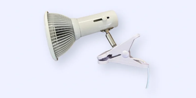 A white clip-on LED lamp with a ribbed lampshade, adjustable neck, and power cord, set against a light background.