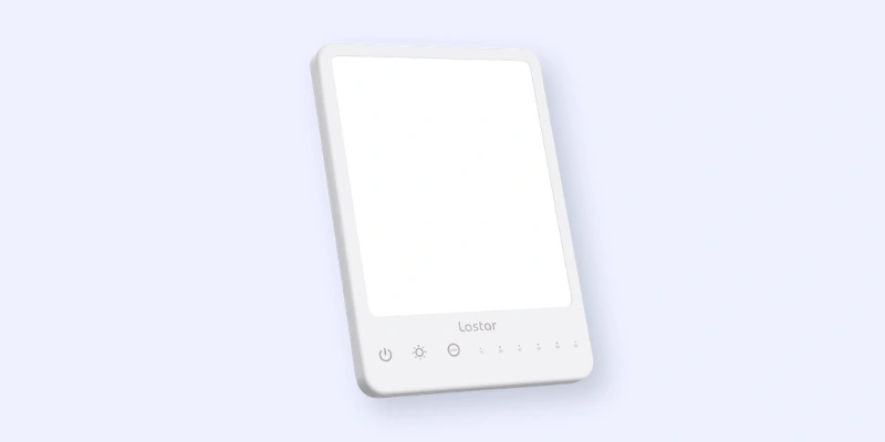 A rectangular white light therapy lamp with touch controls along the bottom, including power and brightness icons. The lamp is standing upright against a light background.