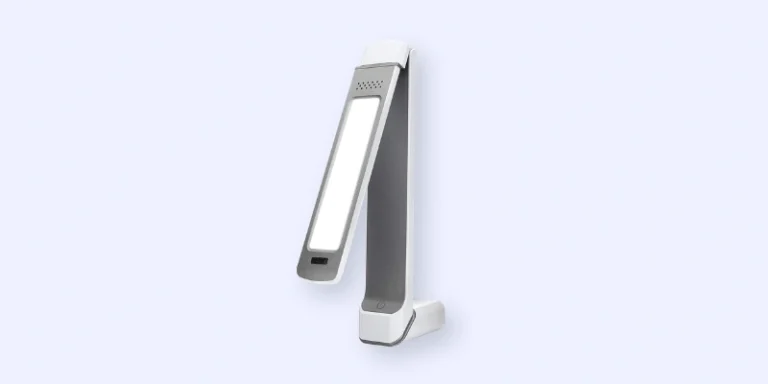 A modern, foldable LED desk lamp with a slim, rectangular design in white and gray, shown partially opened against a light blue background.