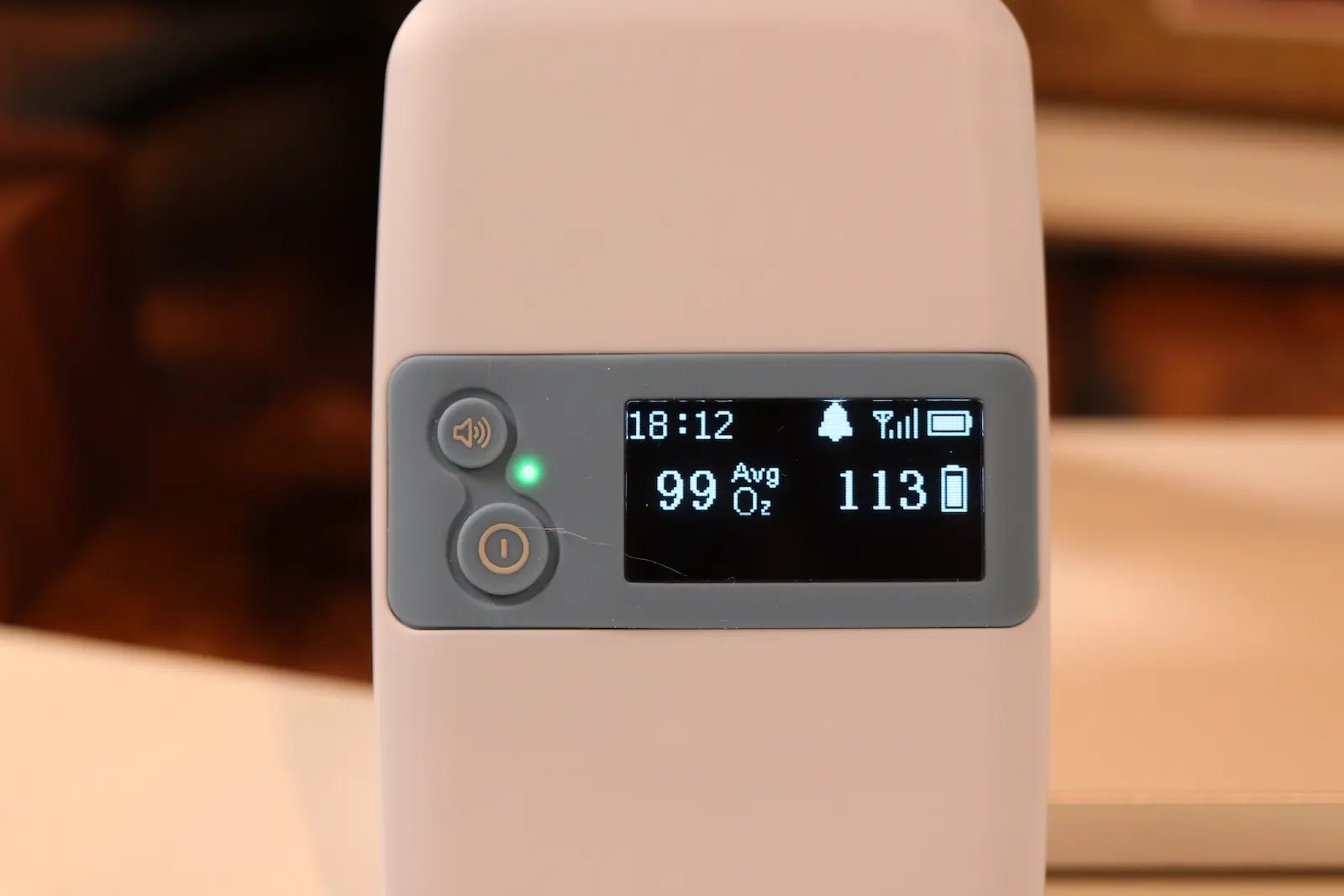Pulse oximeter display showing 99% average SpO2 oxygen saturation and heart rate of 113 BPM at 18:12