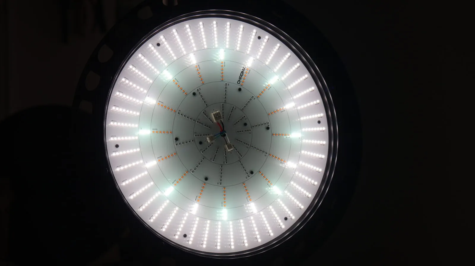 Circular LED grow light panel with white and amber diodes arranged in concentric rings, viewed from below