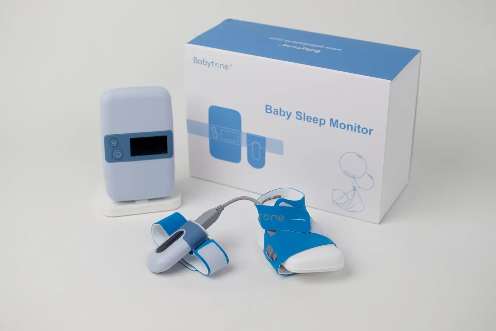 Babytone Baby Sleep Monitor set with display unit, blue wrist and foot sensors, and product packaging box
