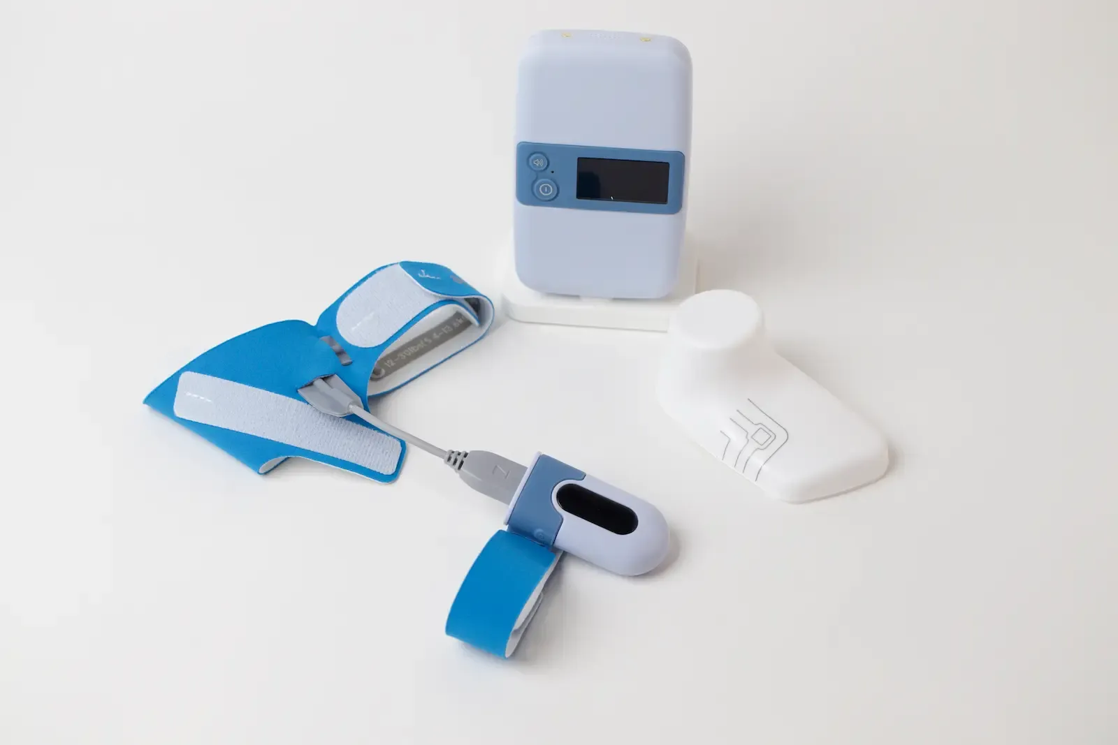 Wearable medical sleep apnea monitoring kit with blue straps, pulse oximeter sensor, body position tracker, and portable reco