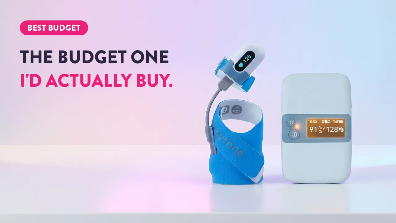 Babytone budget baby monitor showing heart rate 128 and SpO2 91% on base station display with wearable sensor