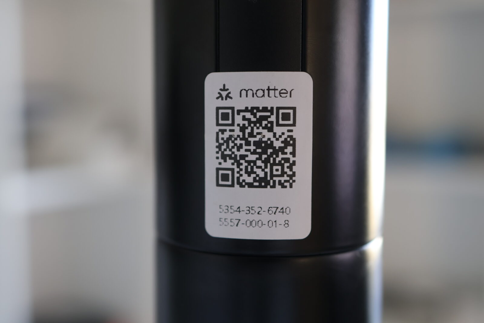 Matter smart home QR code label on black cylindrical device showing pairing code 5354-352-6740