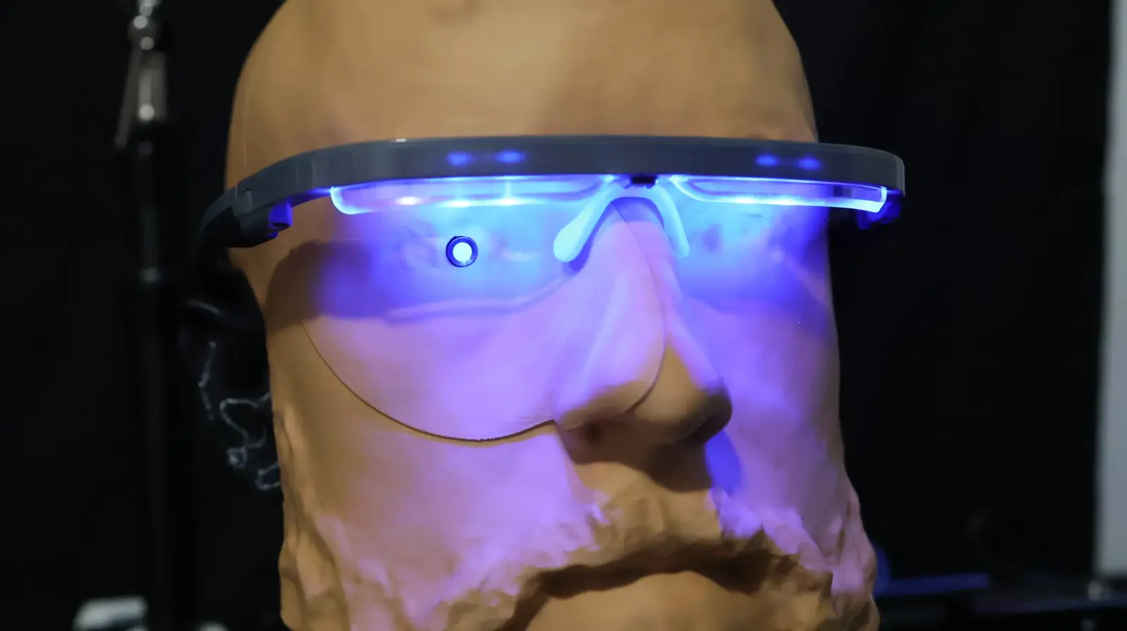 AYO light therapy glasses on a headform with a spectrometer behind the lens