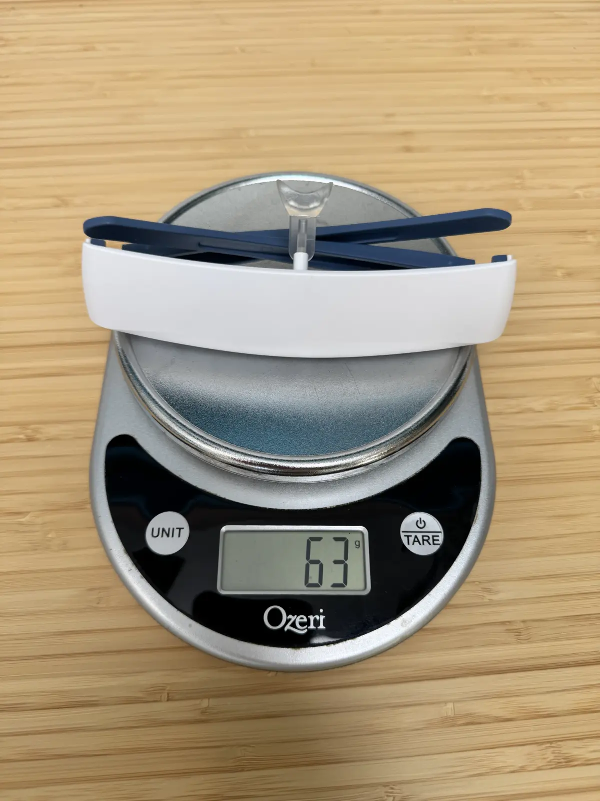 White Luminette 2 on the same kitchen scale reading 63 g