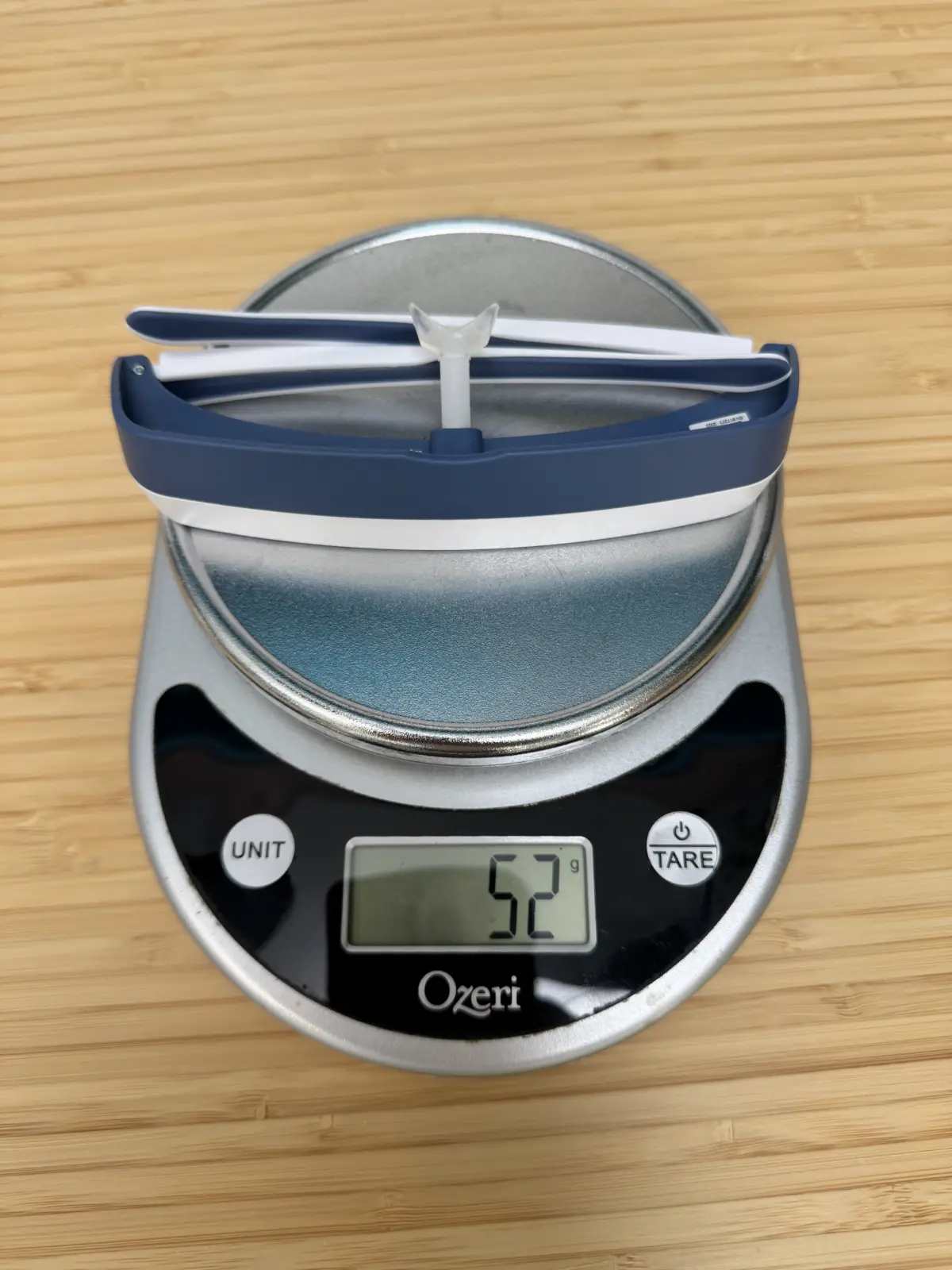 Navy Luminette 3 on a kitchen scale reading 52 g